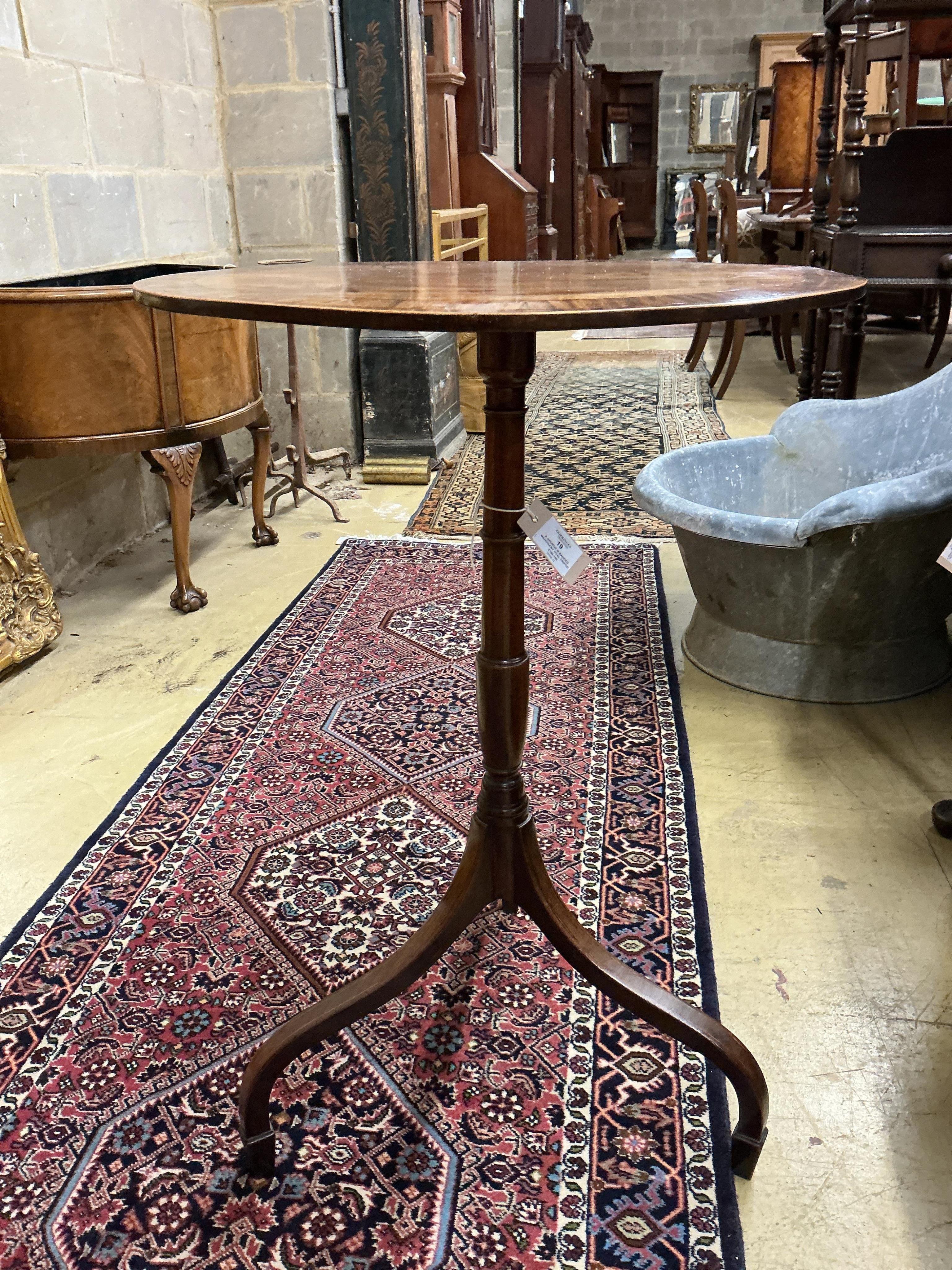 A George III banded mahogany oval tripod wine table, width 52cm, height 76cm